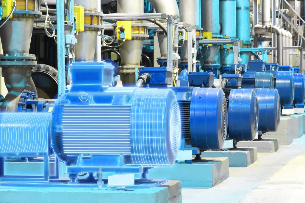 A row of industrial motors and pumps, with a blue digital twin overlay at the first motor and pump