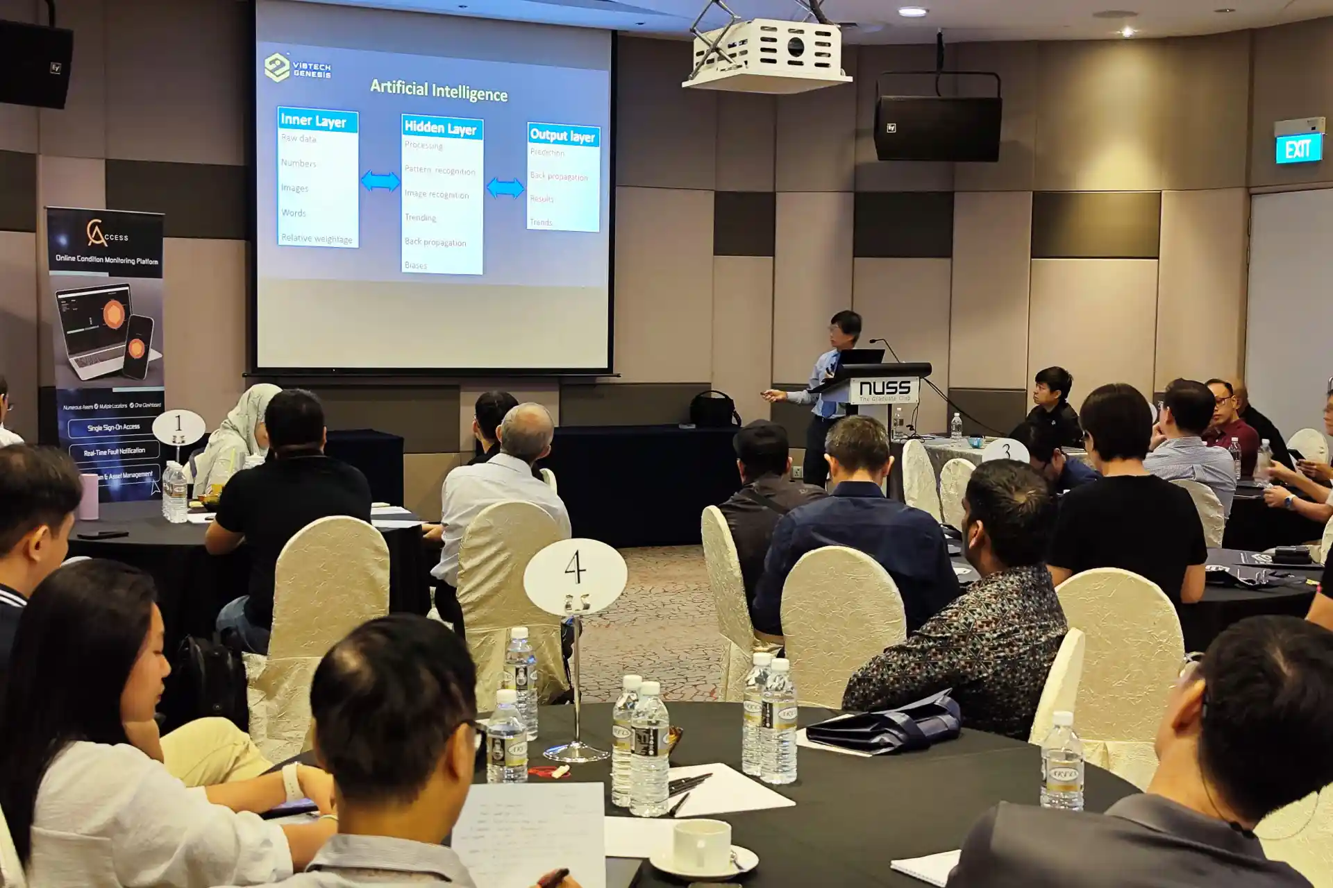 Speaker presenting artificial intelligence concepts at Vibtech Genesis Holistic Plant Development with AI and MCSA Diagnostics Symposium in Singapore.