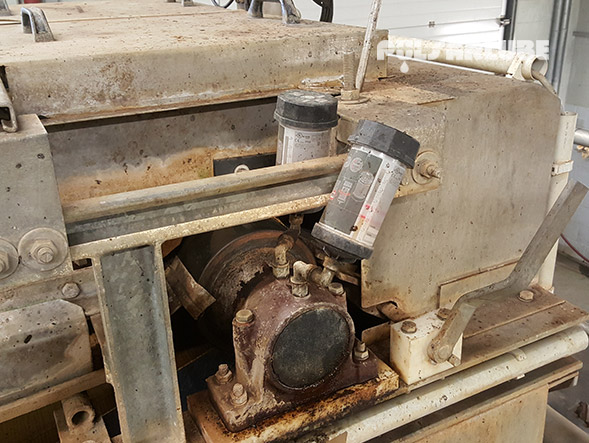 Pulsarlube automatic lubricators installed on industrial machinery near a bearing housing