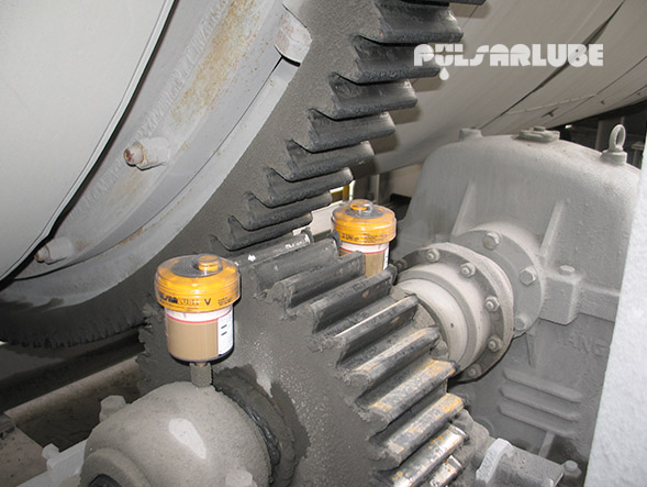Two Pulsarlube V automatic single-point grease lubricators installed on an industrial gear drive