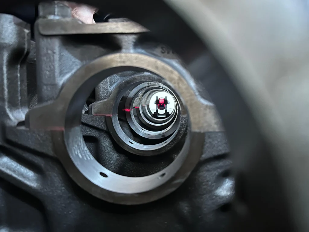 Laser bore alignment setup viewed through a series of bores, with the laser beam reaching a detector at the far end